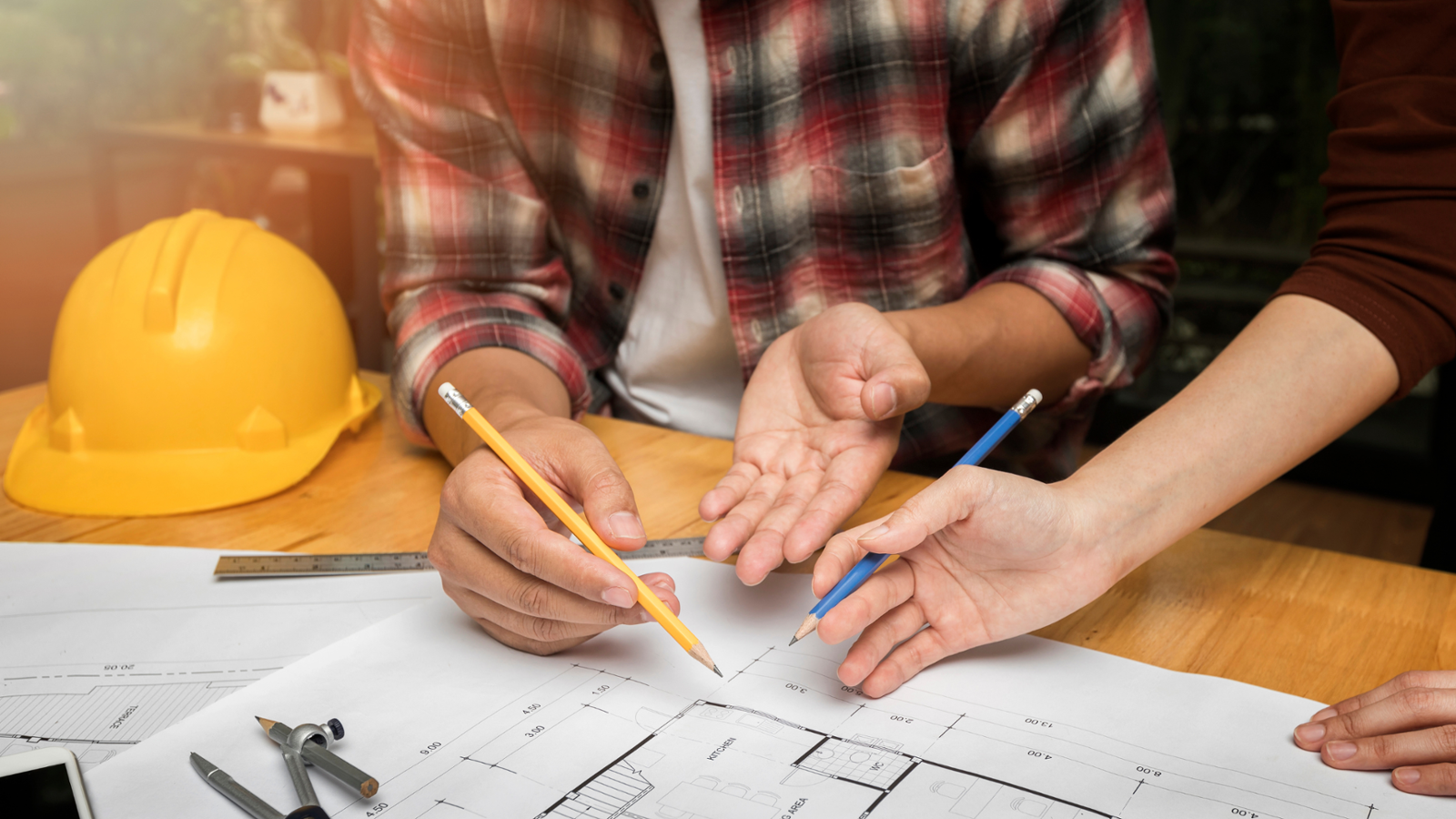 Two people looking at construction plans